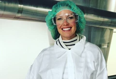 person in protective gear for processing milk