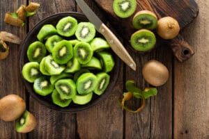 Kiwi fruit on wooden rustic table, ingredient for detox smoothie bowl of kiwis