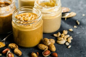 Selection of nut butters – peanut, cashew, almond and sesame seeds nut butter