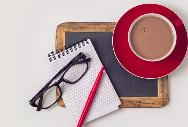 chocolate milk on a desk with work supplies