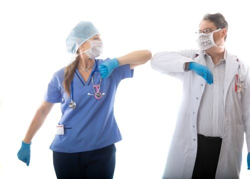 healthcare workers bumping elbos