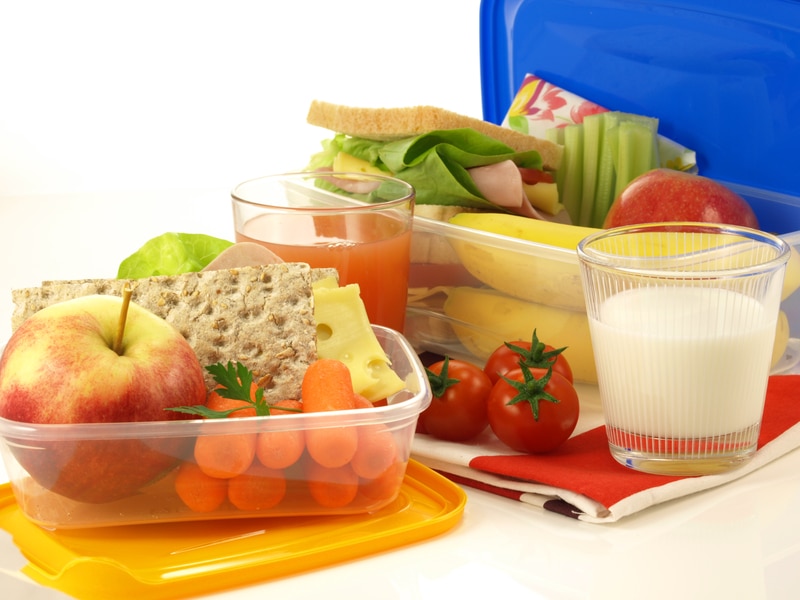 lunch box full of fresh, healthy lunch items and milk