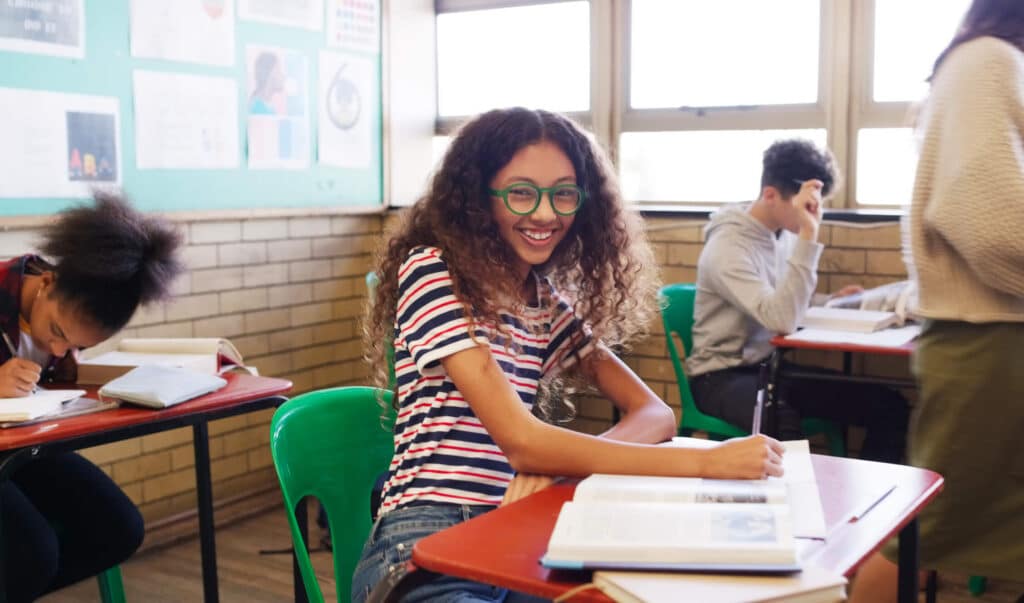 Girl smiling working in class