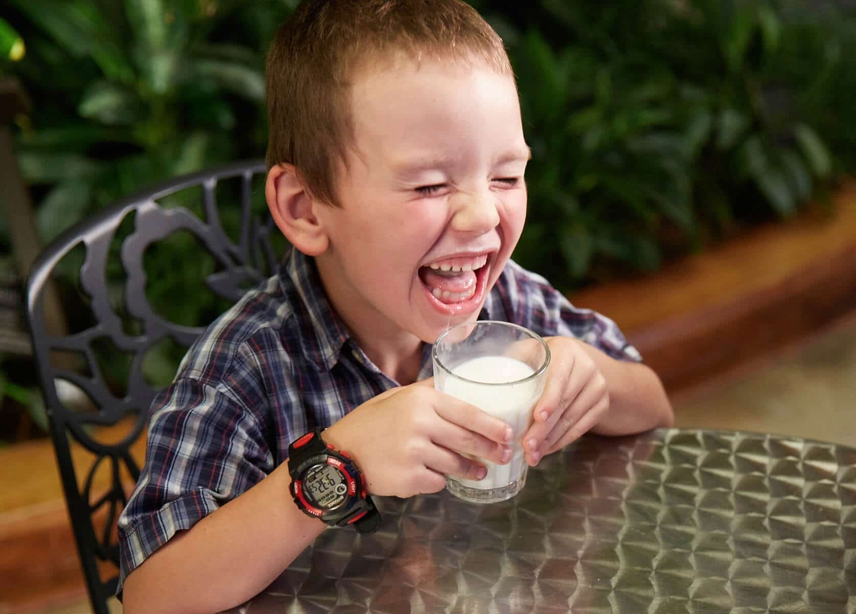kid enjoying a glass of milk,