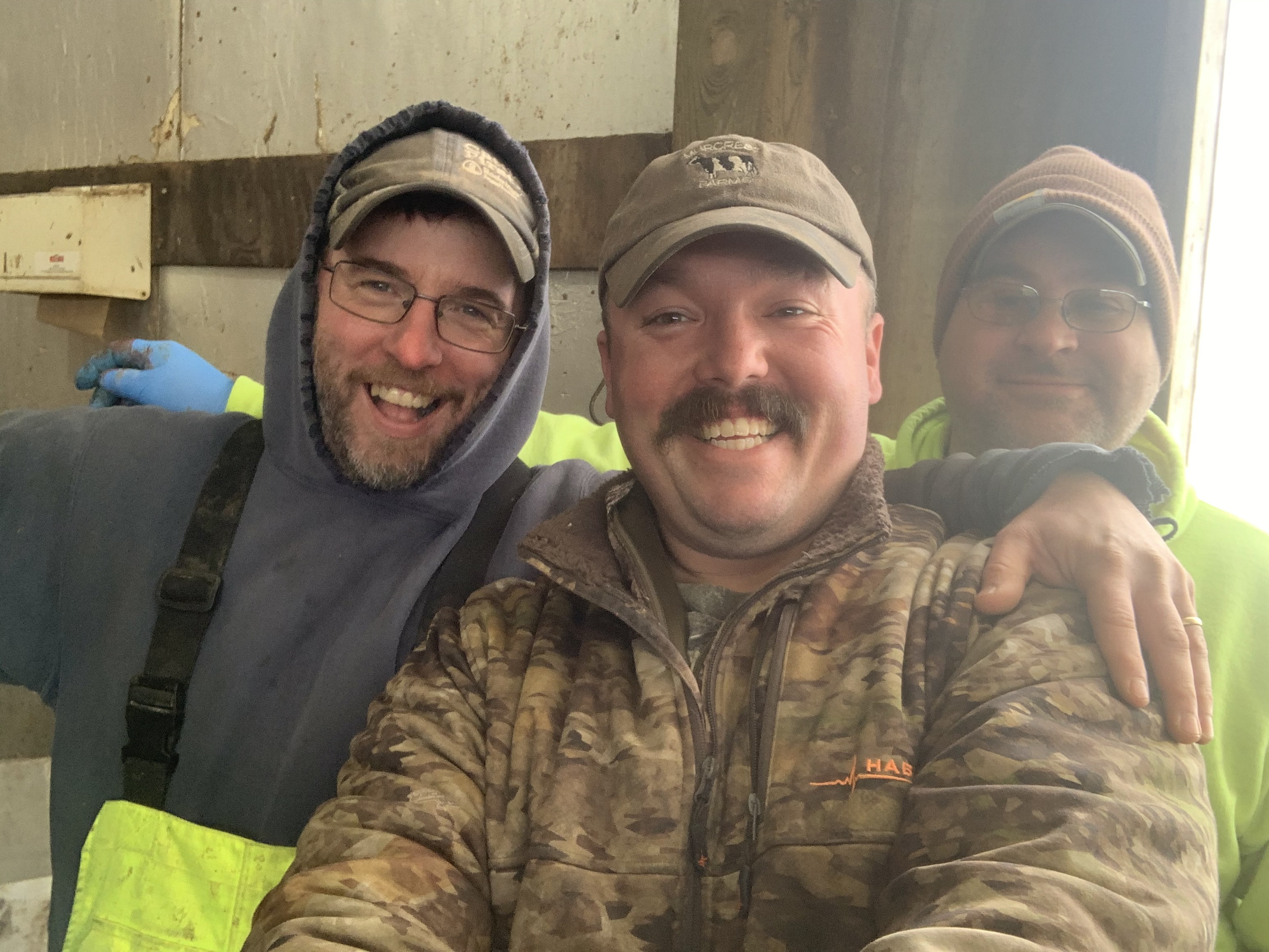 two dairy farmers smiling