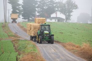 tractor driving hay bales