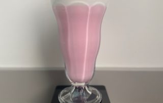 Pink milkshake in a fancy glass