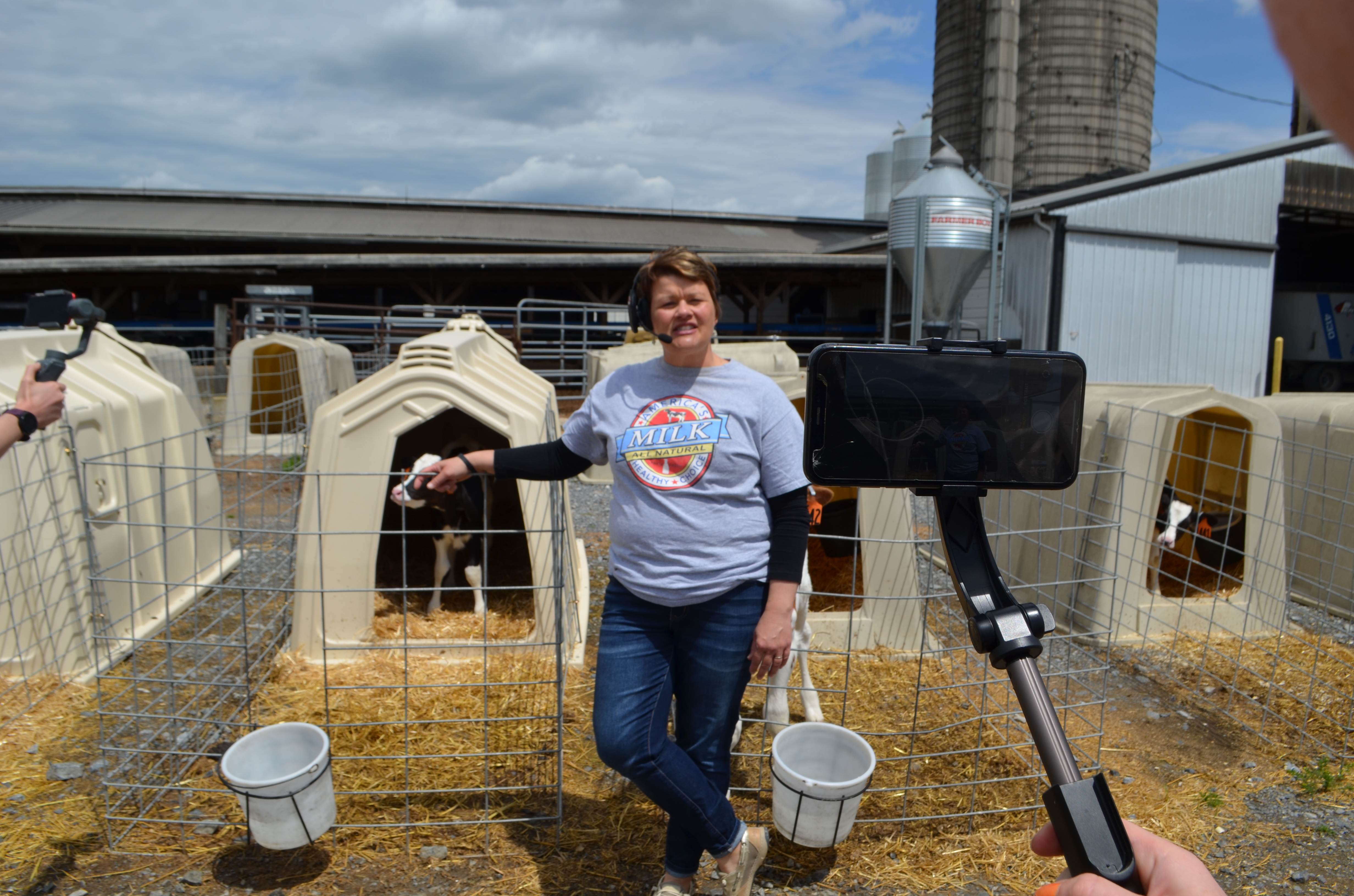 Woman filmed standing in front of a calf pen