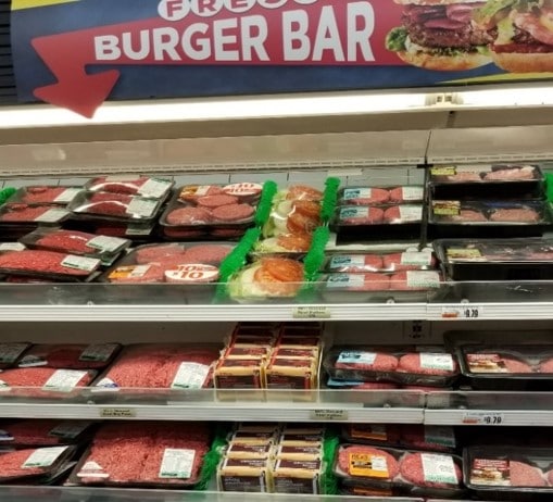 Cheese slices next to hamburger meat at the grocery store