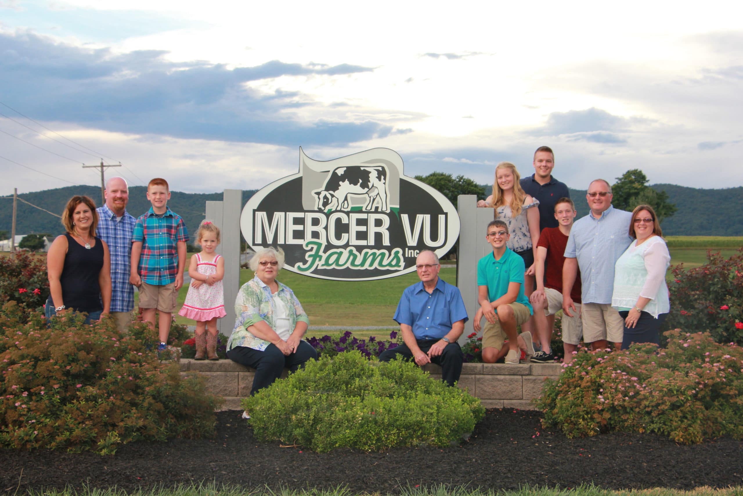 Family sitting in front of Mercer Vu Farms sign