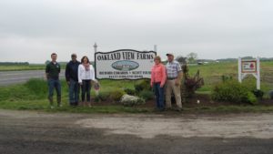 Family standing at the entrance of Oakland View Farms