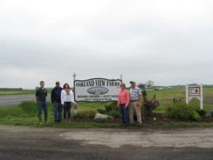 Family standing at the entrance of Oakland View Farms