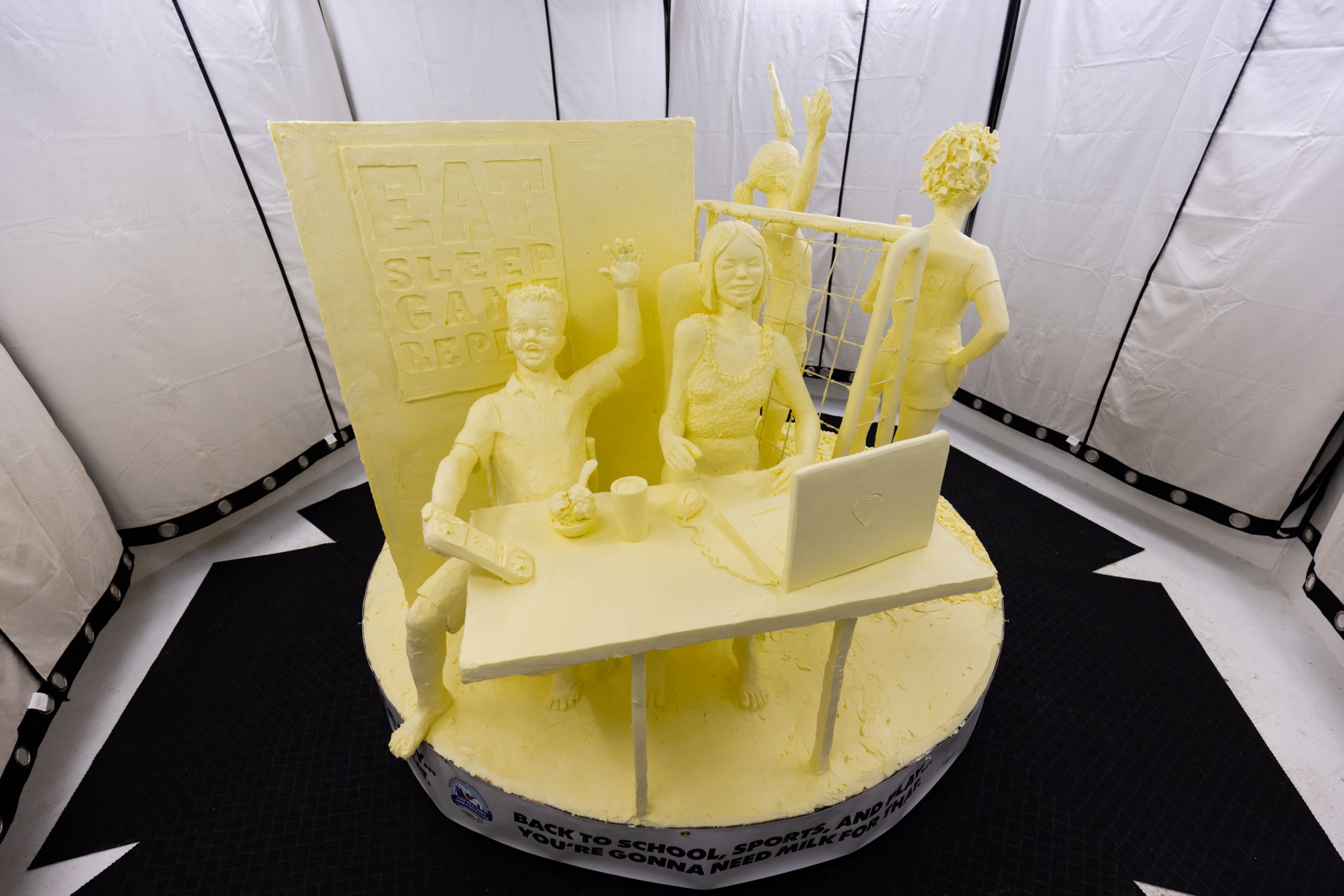 Butter sculpture of kids playing a video game
