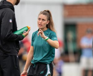 Assistant coach helping a player