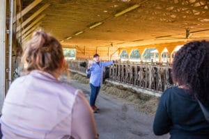 Farmer giving a tour of a barn