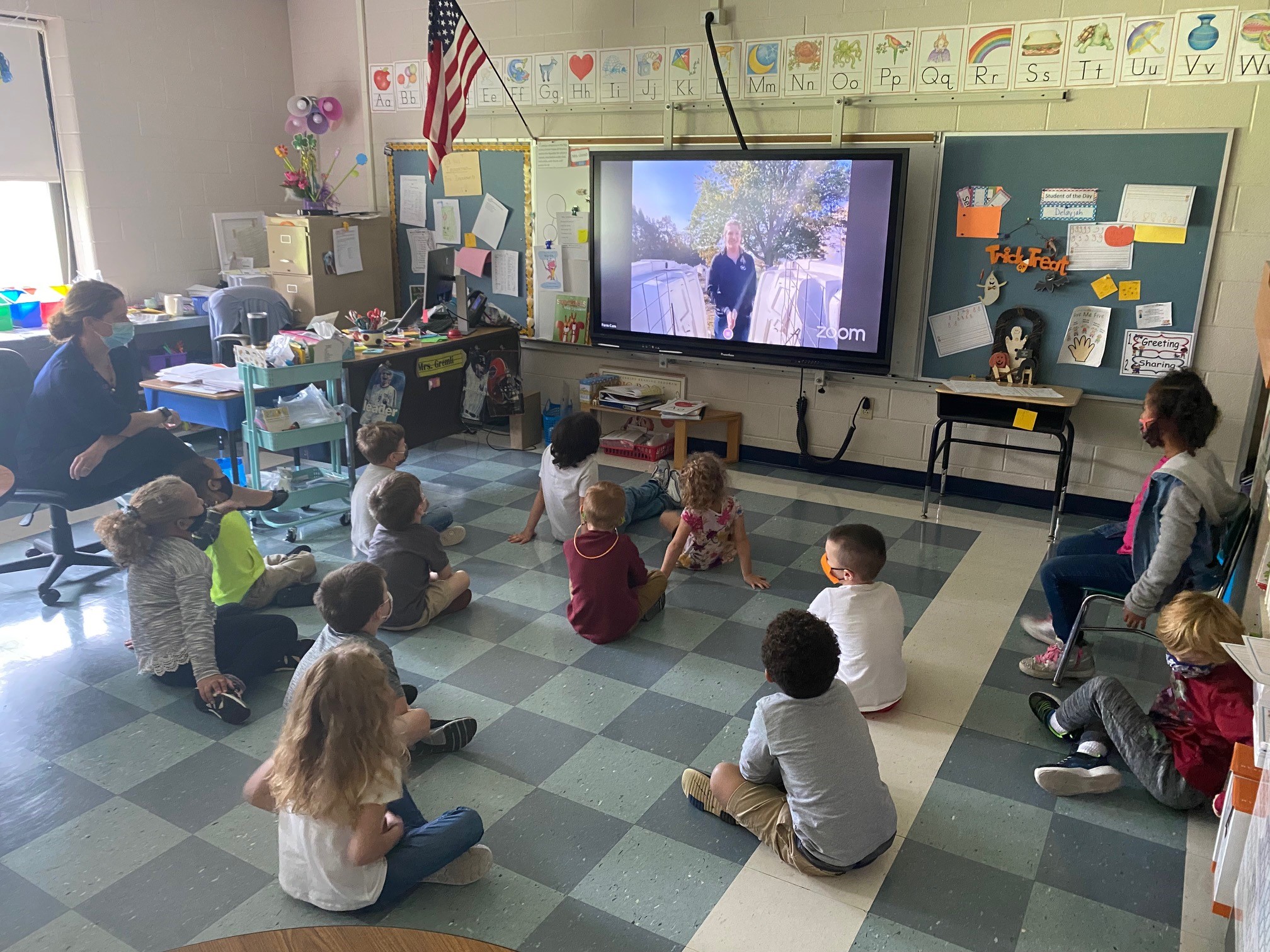Kids in a classroom joining a virtual farm tour via Zoom