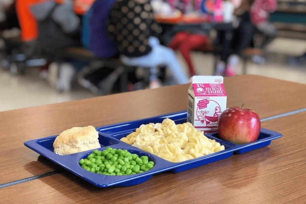 A blue school lunch tray with a can of milk.