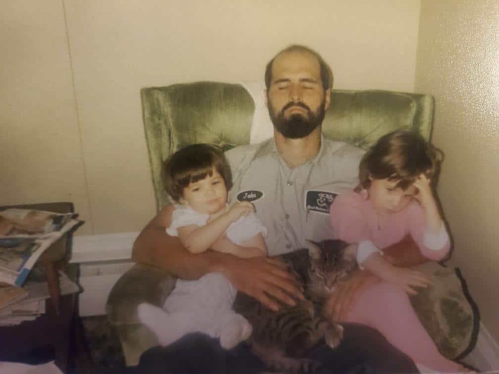 an old photo of a dad with two kids on his lap