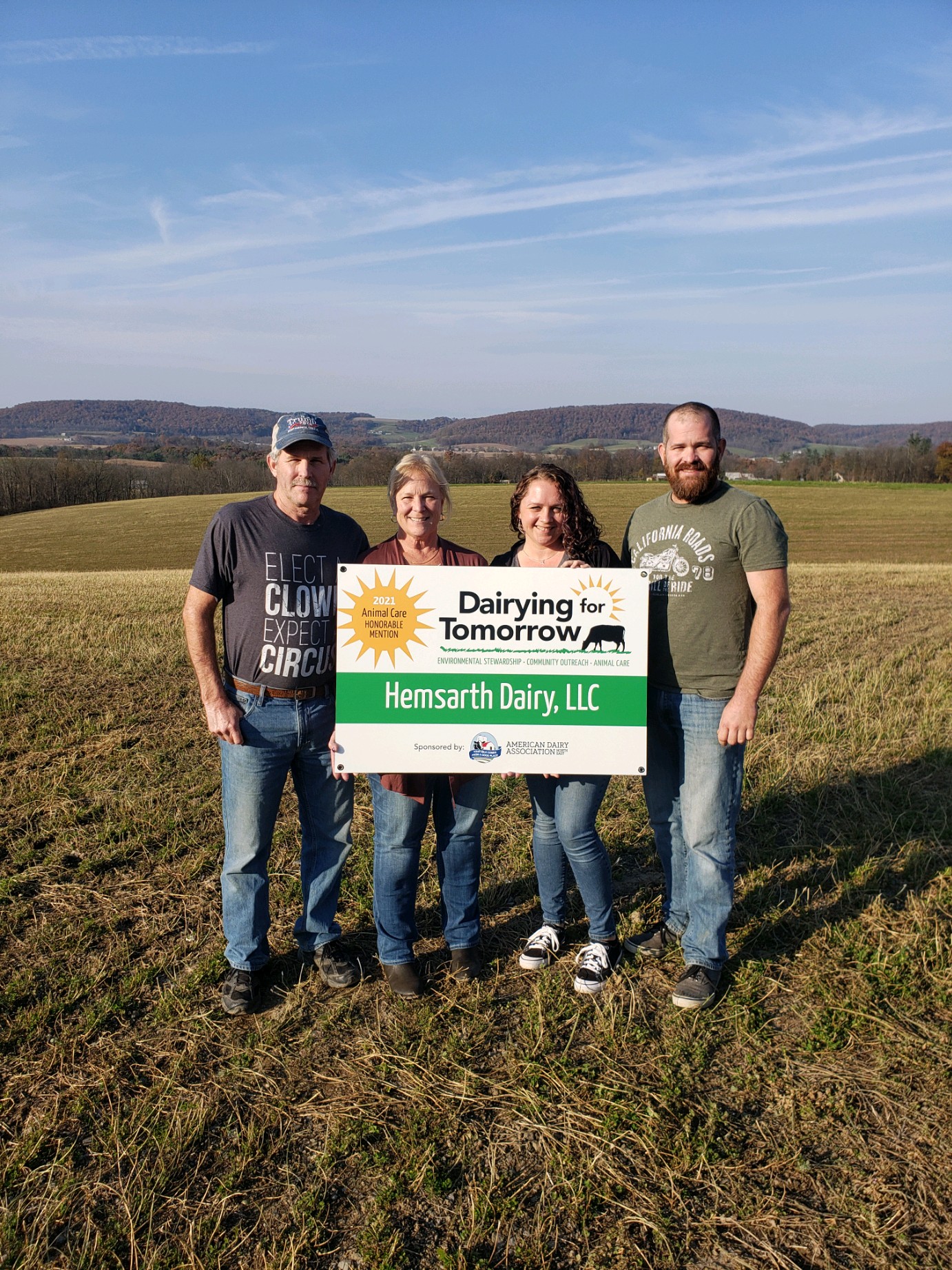 Family holding a Hemsarth Dairy sign