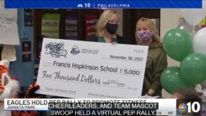 School receiving a large check on the news