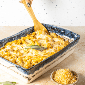 Butternut Squash Pasta Bake Recipe – 4 A ceramic serving tray filled with creamy butternut squash pasta, delicately decorated with a leaf of sage.
