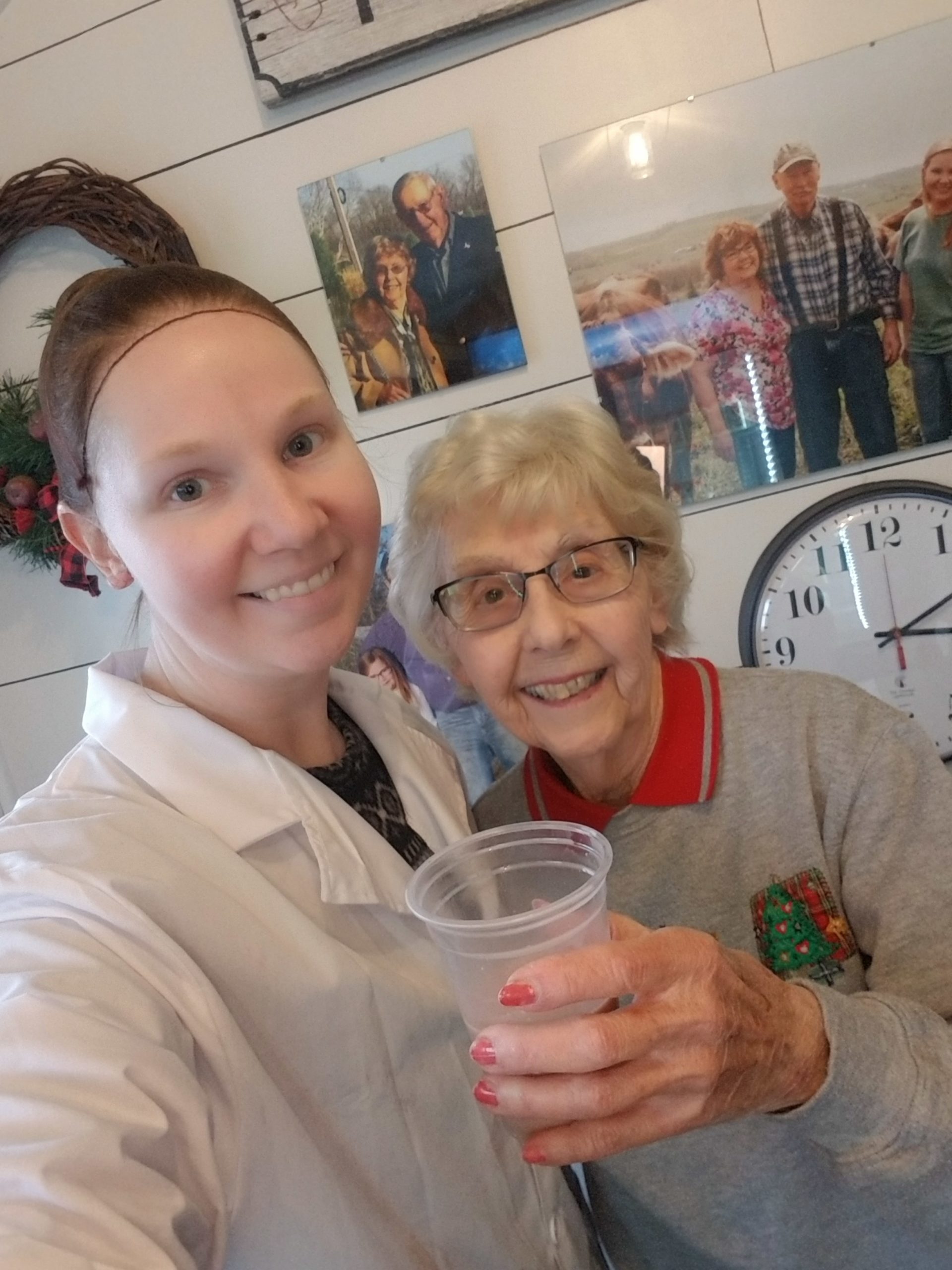 A young dairy farmer and her grandmother toasting with a glass of chocolate milk.
