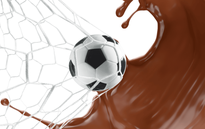 A soccer ball pushing a goal net, with a splash of chocolate milk behind it.