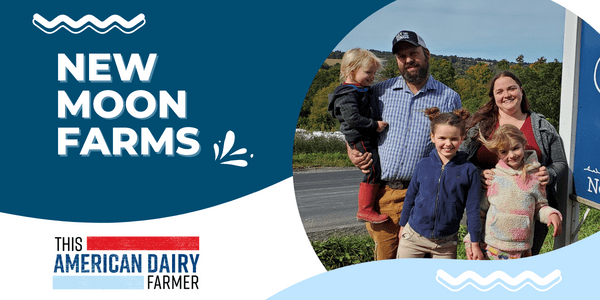 A farm couple and their children standing next to a sign welcoming visitors to New Moon Farms.