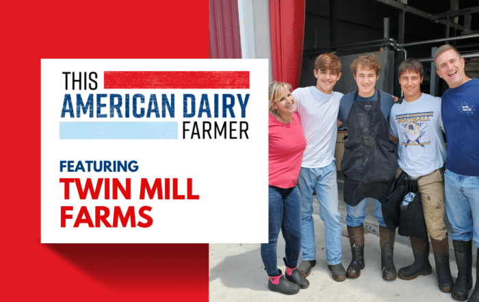 A dairy farming family standing outside their barn at Twin Mill Farms.